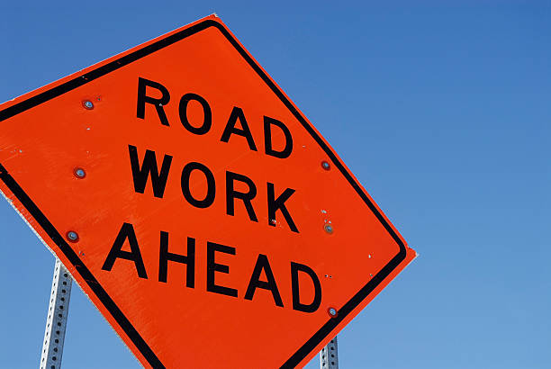 Construction road sign against a blue sky